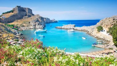 Rodi Lindos Baia di St Paul - Vista pittoresca della baia di Lindos con acque turchesi e l'Acropoli in cima alla collina, Isola di Rodi, Grecia.